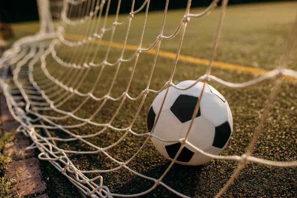 An image of a Soccer ball in the gate net.