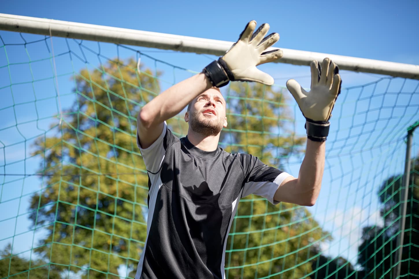 An image of a goalkeeper or soccer player at a football goal.