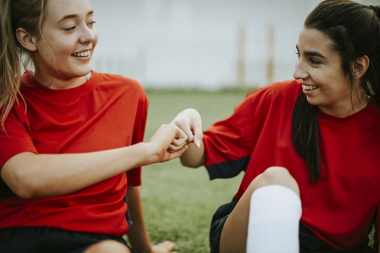 An image of Happy female rugby players doing a fist bump.
