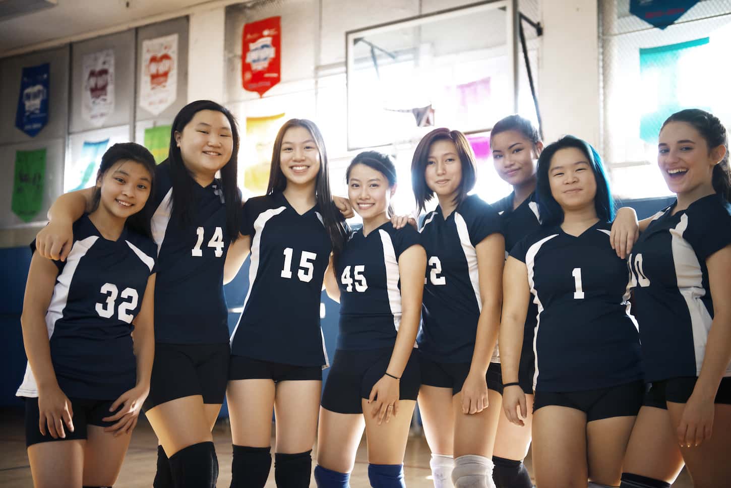 An image Of Teenage Girls Volleyball Team On the Court.