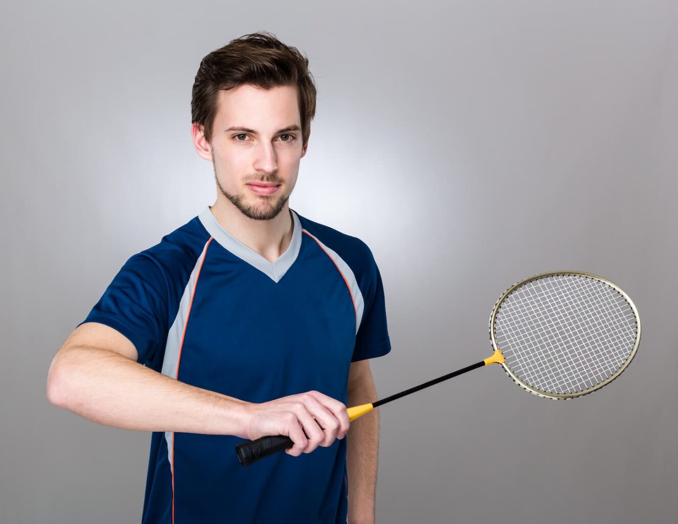 An image of a Sportsman holding a  badminton racket.
