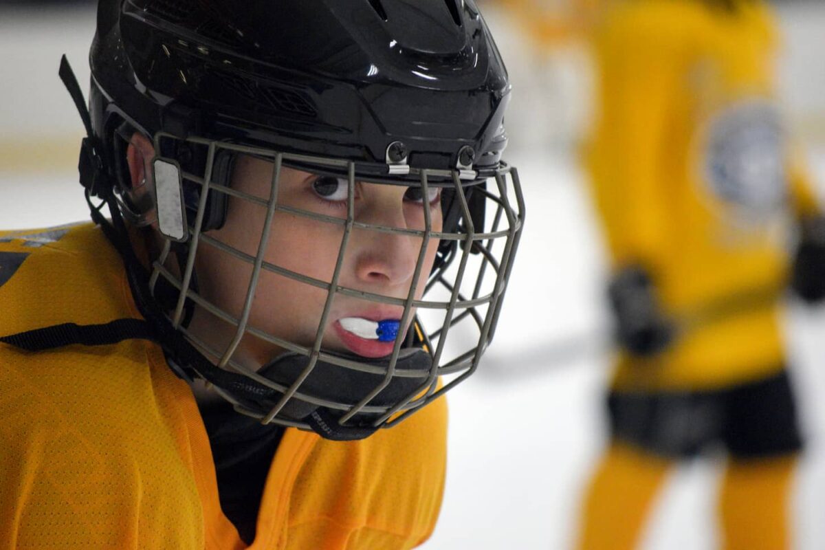 An image of a young hockey player in full gear inside the ice rink.